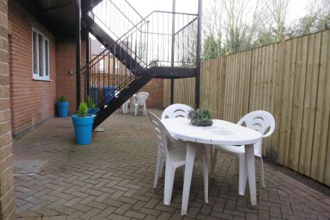 Private paved courtyard with a dining table and...