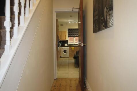 Bright, well-maintained hallway with wooden flo...