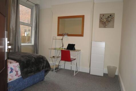 Bright, neatly presented bedroom with a study d...