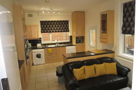 Bright open-plan kitchen with light wood cabine...