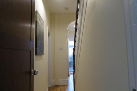 Bright, well-kept hallway with polished wooden ...