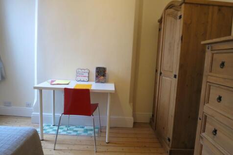 Bright, simply furnished bedroom nook with a wh...