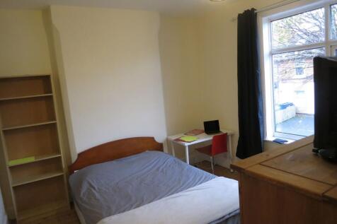 Bright double bedroom with a large window, simp...
