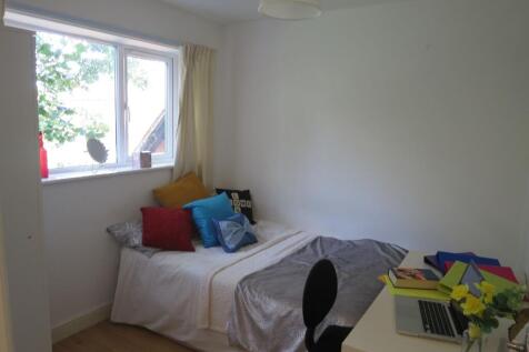 Bright, neatly presented bedroom with a comfort...