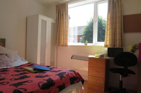 Bright double bedroom with a large window, simp...