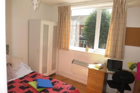 Bright, neatly presented bedroom with a large w...