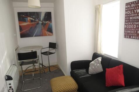 Bright, neatly presented living area with a com...