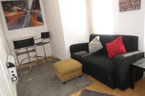 Bright compact living area with a black two-sea...