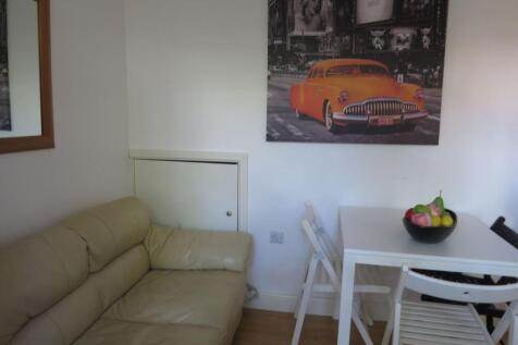 Bright, simply furnished living area with a com...