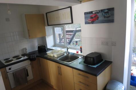 Bright fitted kitchen with wood-effect cabinets...