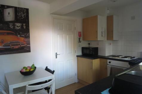 Bright, tidy kitchen with light wood cabinets, ...
