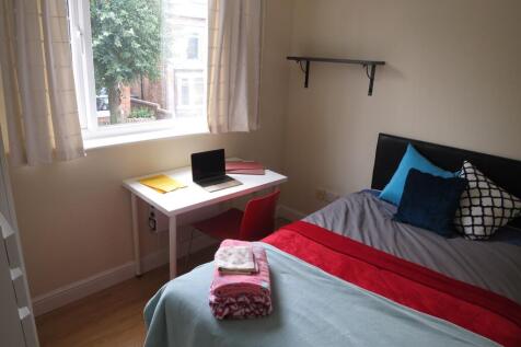 Bright, neatly presented bedroom with a comfort...