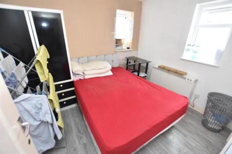 Bright, simply furnished bedroom with a double ...