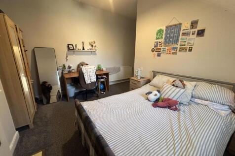 Bright, neatly kept double bedroom featuring a ...