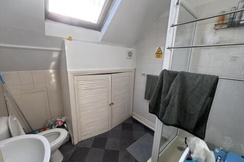 Compact bathroom with a shower cubicle, skyligh...