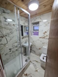 Modern bathroom featuring elegant marble-effect...