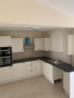 A clean and well-lit kitchen with modern applia...