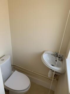 A small and tidy single toilet with basic fixtu...