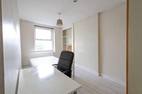 Bright, simply furnished bedroom with a large w...