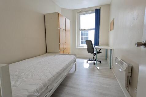 Bright single bedroom with a large window, simp...