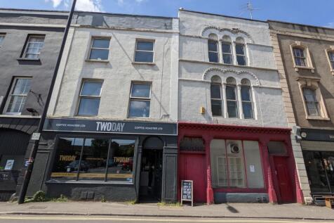 Traditional terraced shopfronts on a sunny stre...