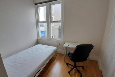 Bright single bedroom with a large window, simp...