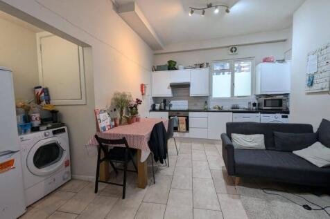 Bright open-plan living area with a modern fitt...