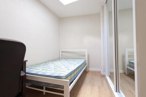 Bright, simply furnished single bedroom with a ...