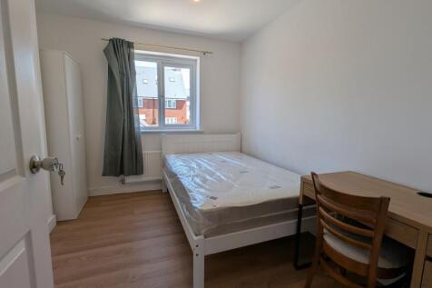 Bright, simply furnished single bedroom with a ...