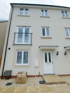 Modern three-storey terraced house with a clean...