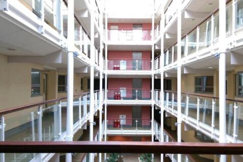 Bright, modern internal atrium with glass balus...