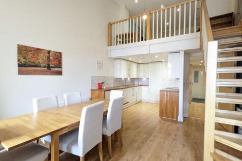 Bright open-plan living and dining area with hi...