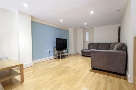 Bright, modern living room with light wood floo...