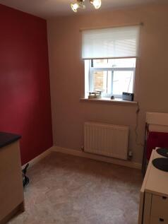 Compact kitchen with a window above the radiato...