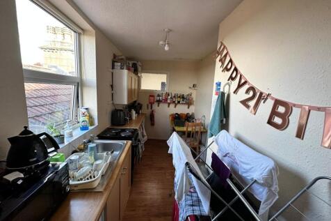 A bright kitchenette with ample natural light, ...