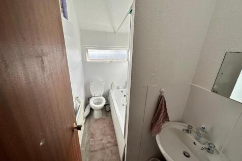 A well-maintained bathroom featuring a bath and...