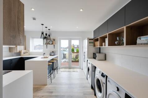 A modern kitchen with a clean design, ample nat...