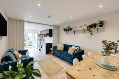 A spacious and well-lit modern living room feat...