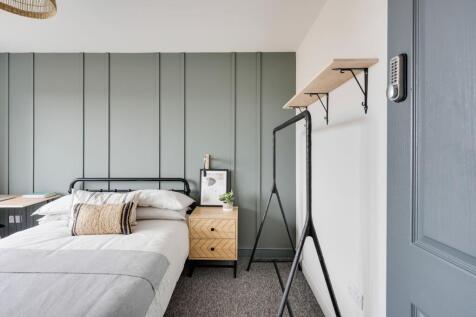 Bright, stylish bedroom with a metal-framed dou...