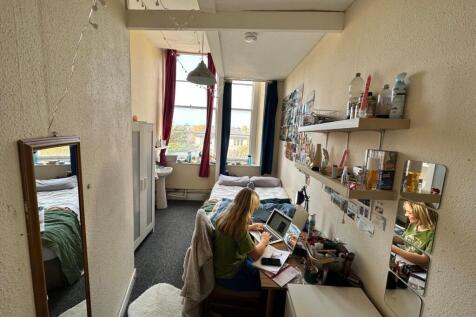 A bright and inviting double bedroom with a stu...