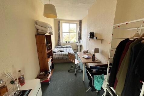 A cozy double bedroom offering good natural lig...