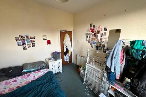 A cozy double bedroom featuring personal decor ...