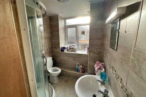 A tidy and well-lit bathroom featuring a modern...