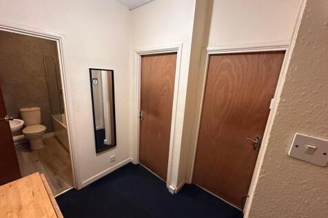 Neat entrance hallway with dark carpet, a full-...