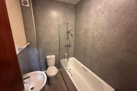 Neat modern bathroom with a white bathtub and s...