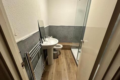 Modern compact bathroom with a pedestal sink, w...