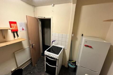 Compact communal kitchen with freestanding elec...