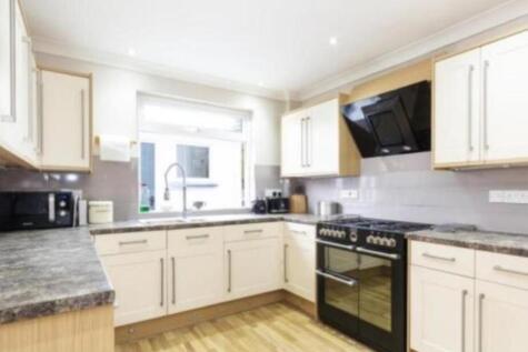 A modern and spacious kitchen featuring ample s...