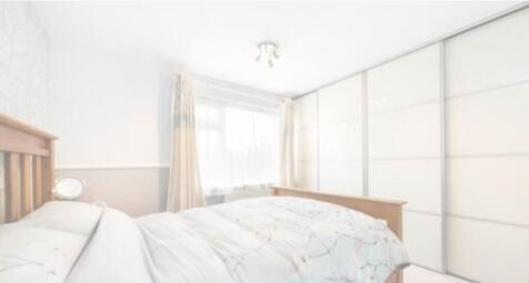 A bright and inviting double bedroom with ample...