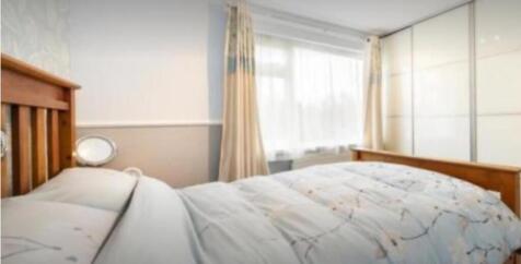 A bright and inviting double bedroom featuring ...